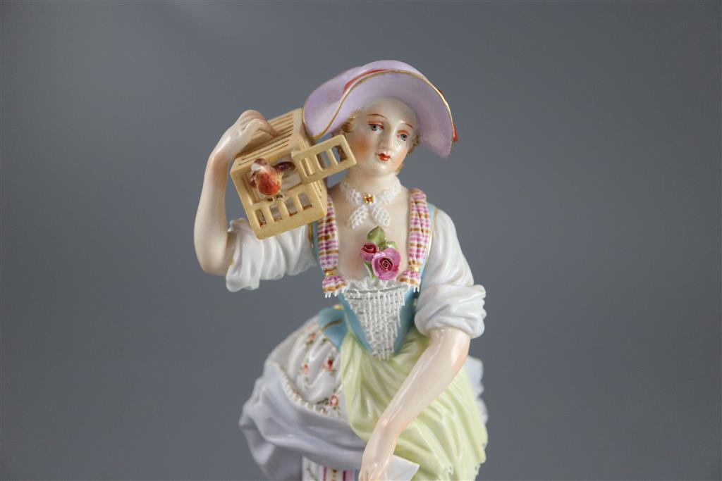 A Meissen figure of a shepherdess releasing a bird from a cage, 19th century, 17.5cm high